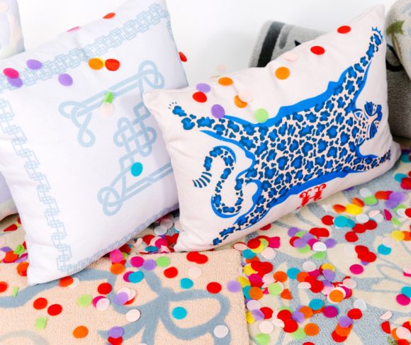 pillow with blue leopard skin rug with confetti on floor