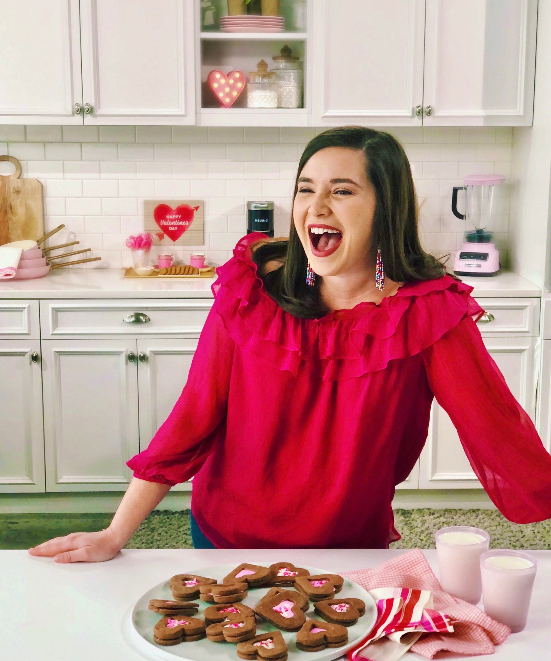 ivy odom in white kitchen laughing and making cookies