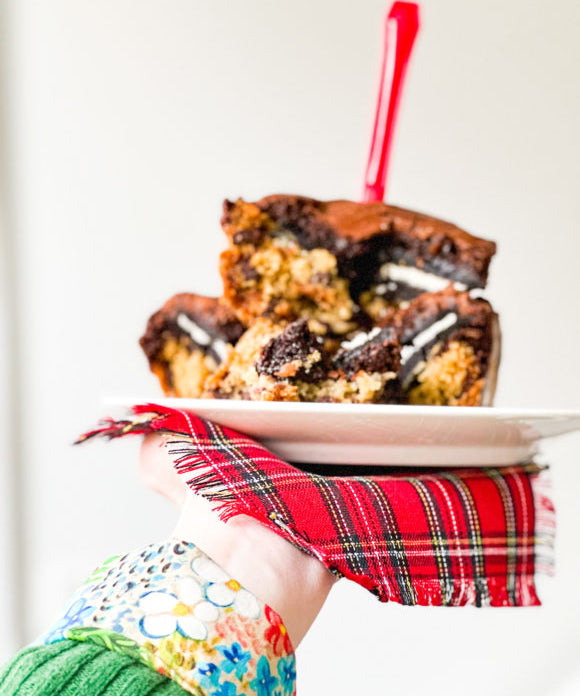 super bowl brownies on white plate with red plaid napkin being held in hand and with red fork