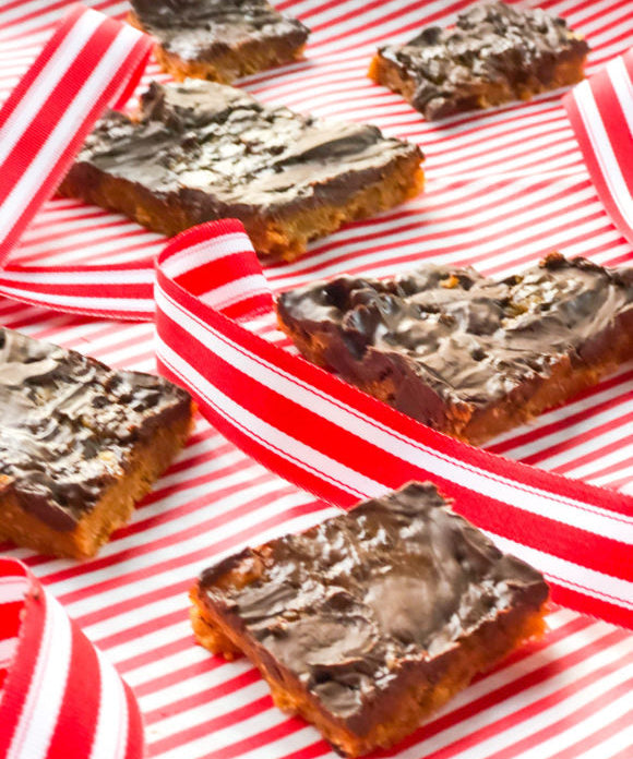 chocolate butterscotch candy on red and white striped paper with red and white striped ribbon