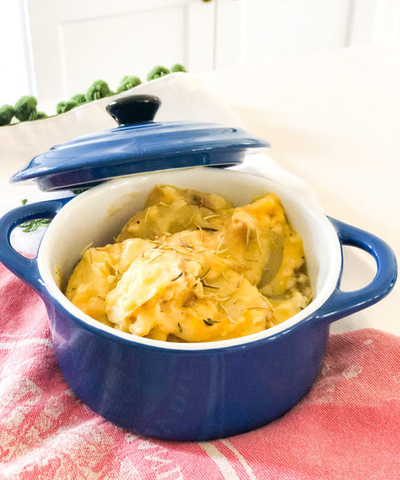 potato au gratin in blue le crueset pot