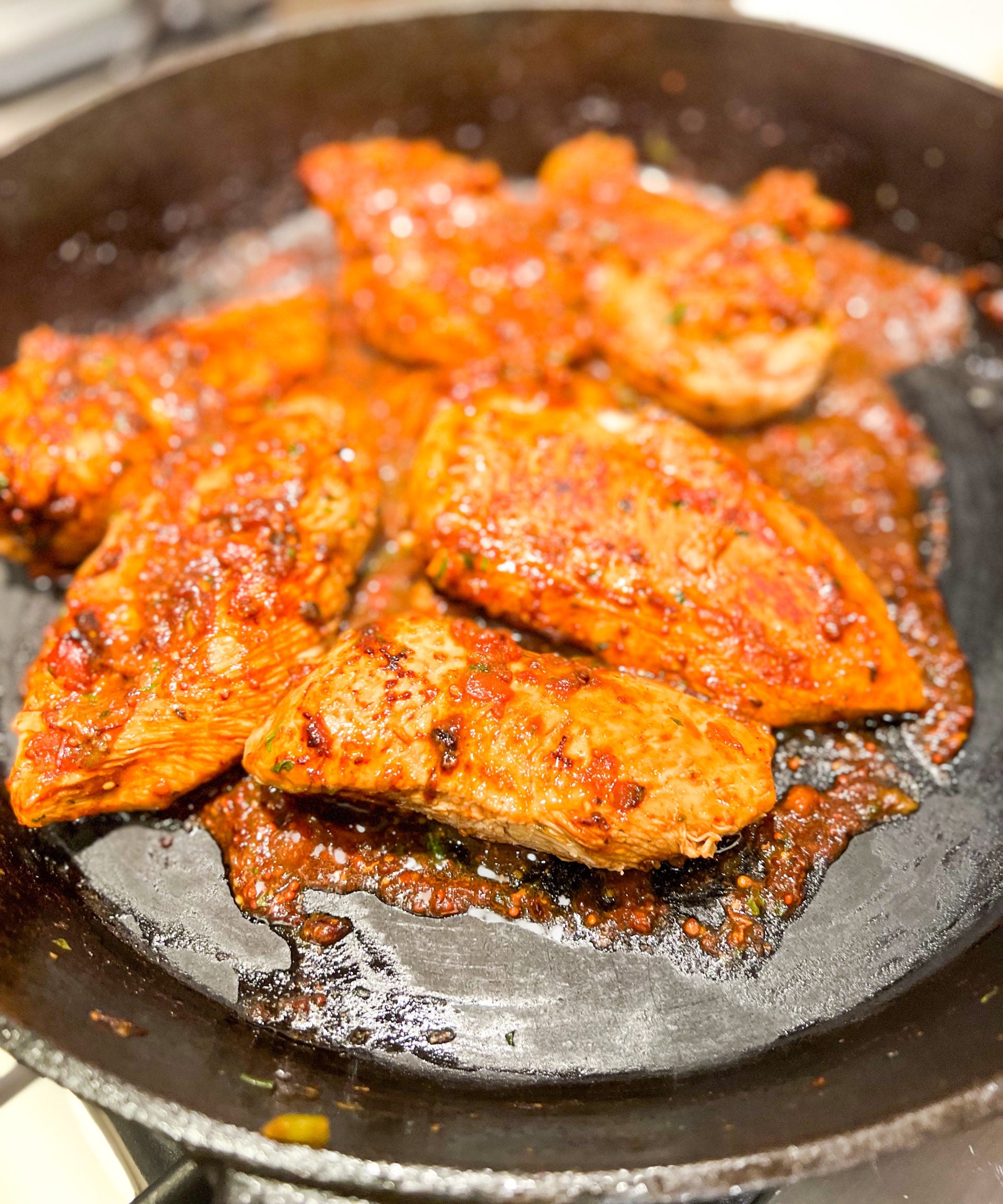 chicken ole with salsa and mustard marinade in cast iron skillet