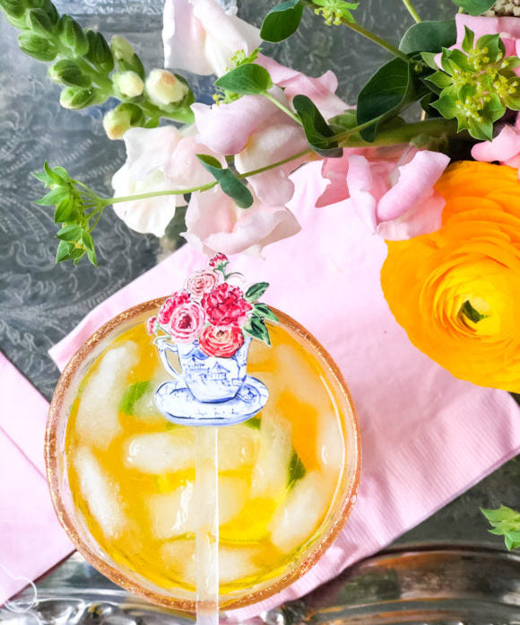 orange soda cocktail with stir stick on top of glass
