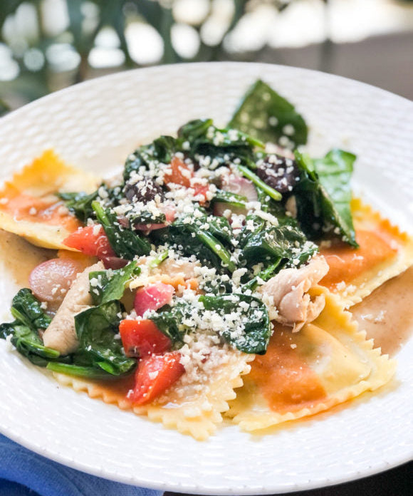ravioli with spinach and tomatoes and cheese