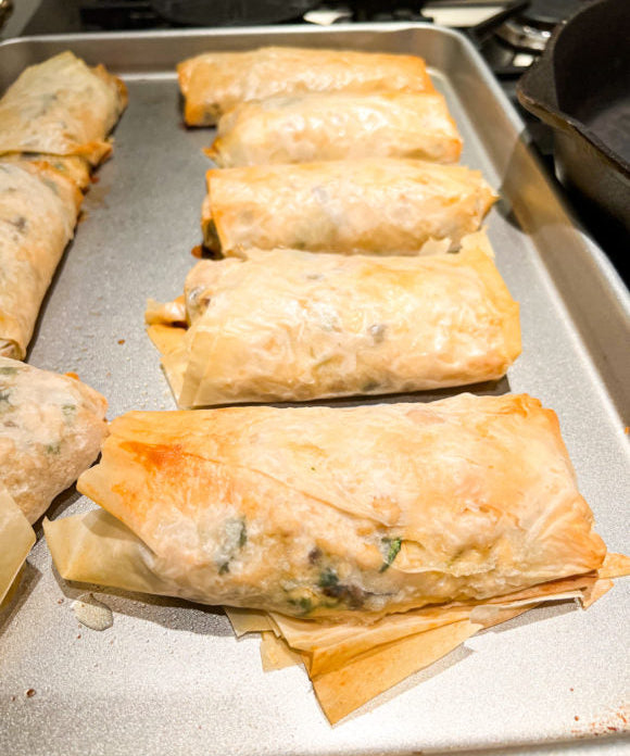 chicken mushroom phyllo rolls on silver baking pan fresh from the oven