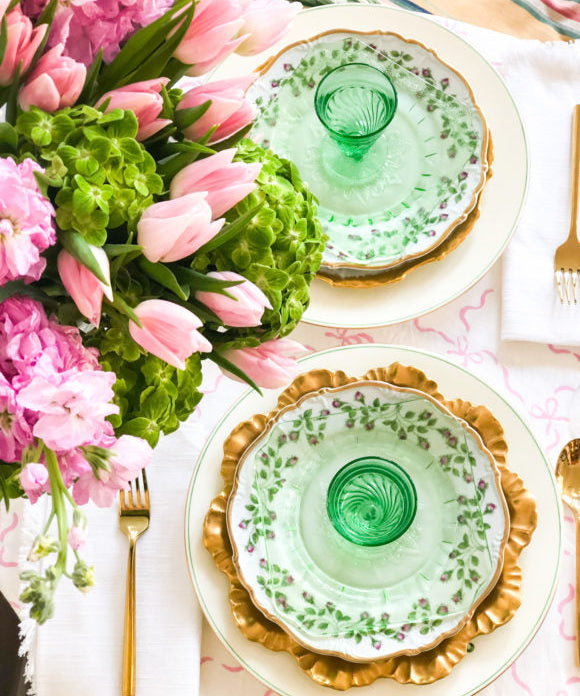 green table setting for two with pink flowers
