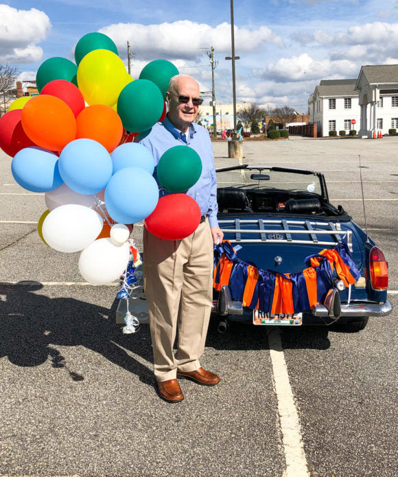 birthday celebration with balloon bouquet and mg car