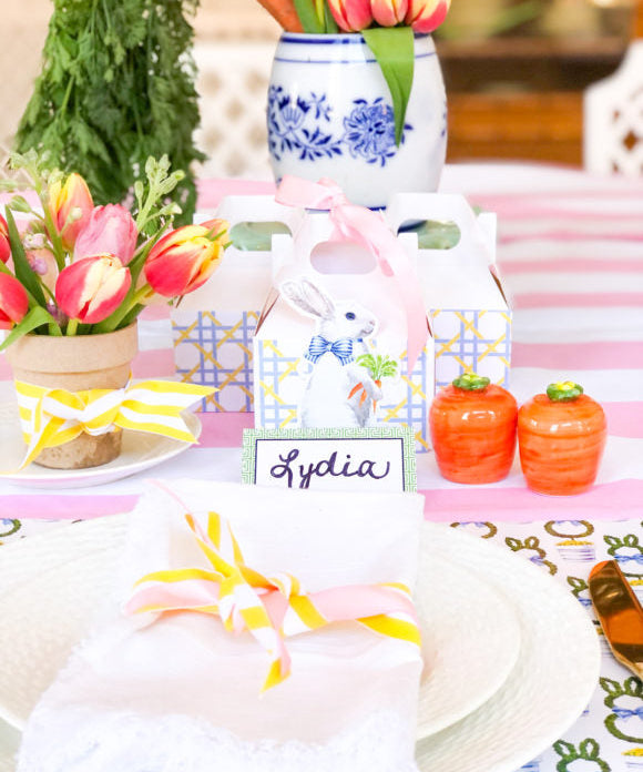 easter table setting with tulips white napkins yellow ribbons vintage carrot salt and pepper shakers