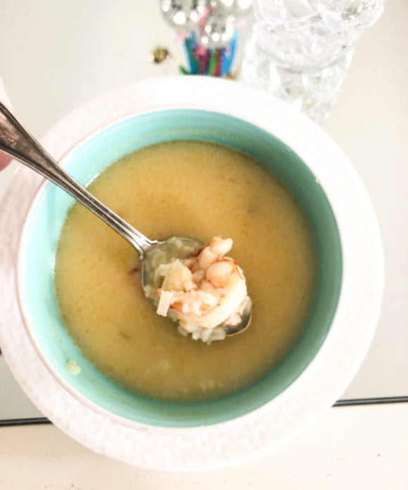 spicy thai shrimp soup in blue bowl and white plate