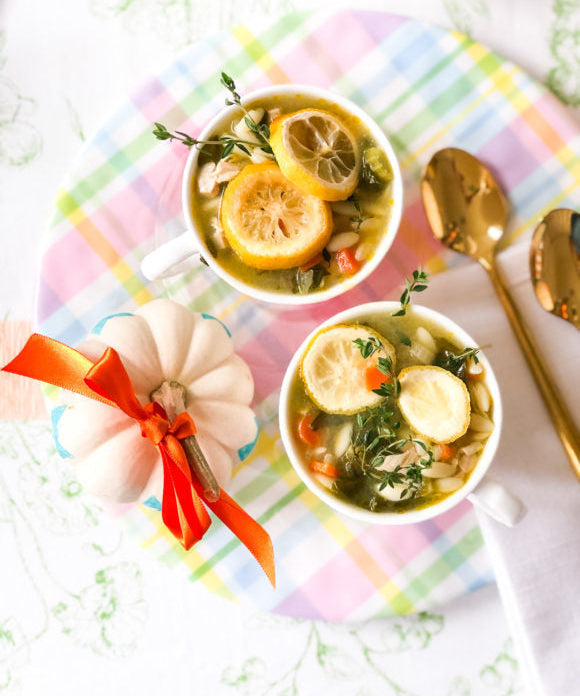 chicken orzo soup in cups on plaid plate