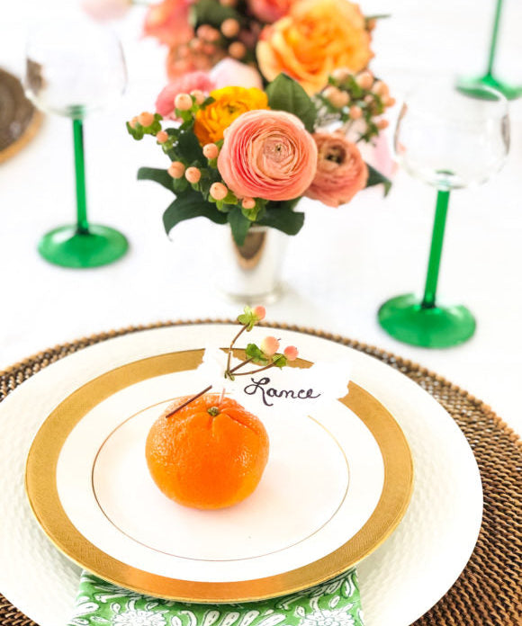 table setting with orange and lance name place card