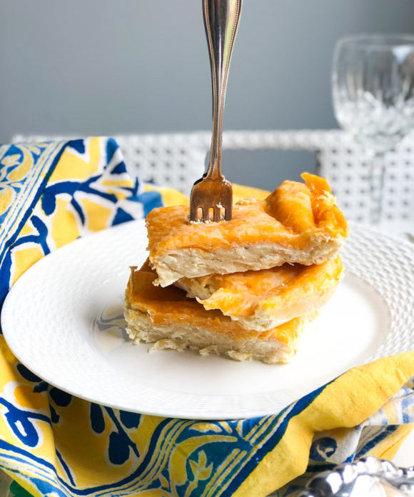 cheesy chicken enchiladas cut into slices with fork at top