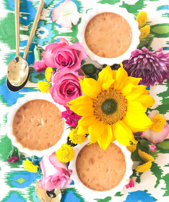 caramel pots de creme surrounded by flowers