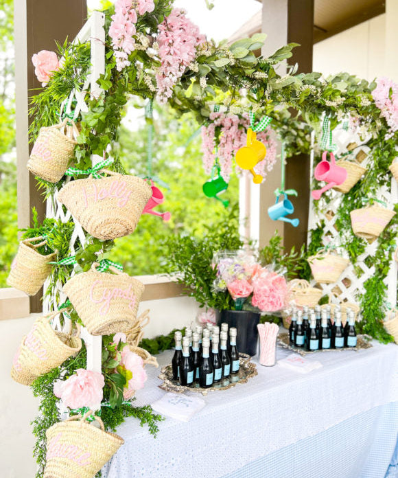 party display of flower market with lattices greenery flowers and straw baskets