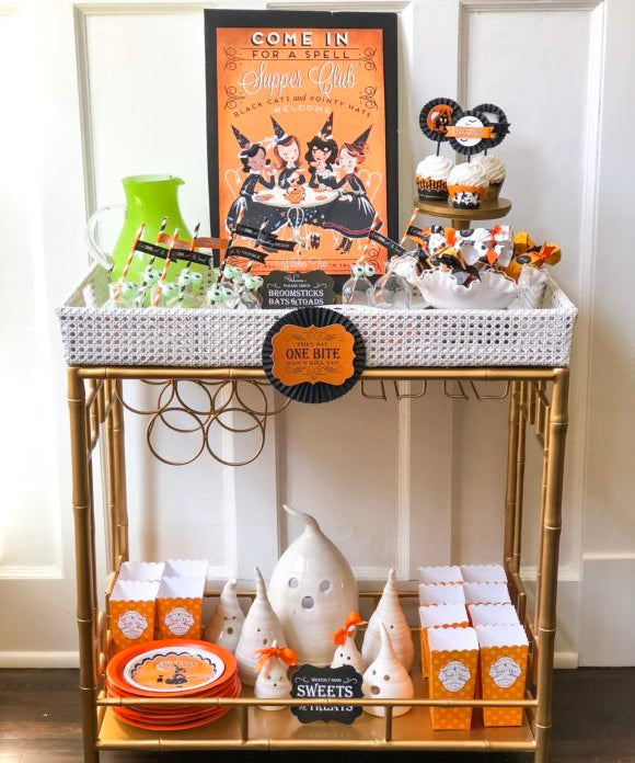 bar cart decorated for halloween with cupcakes drinks popcorn candles