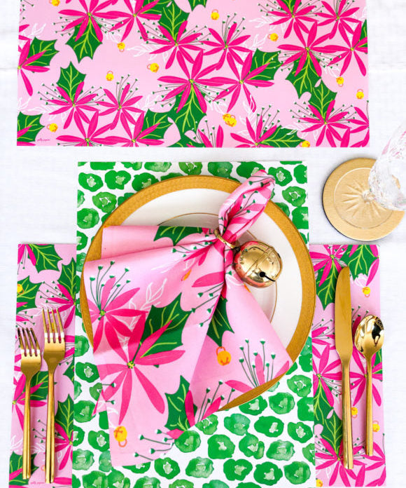 pink and green poinsettia and jingle bell christmas napkins and placemats with green leopard print