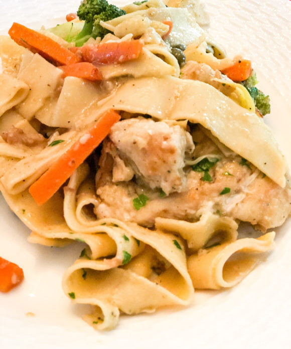 chicken piccata with egg noodles carrots and broccoli