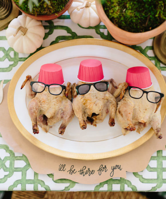 cornish hen turkeys dressed with mini glasses an red mini cups