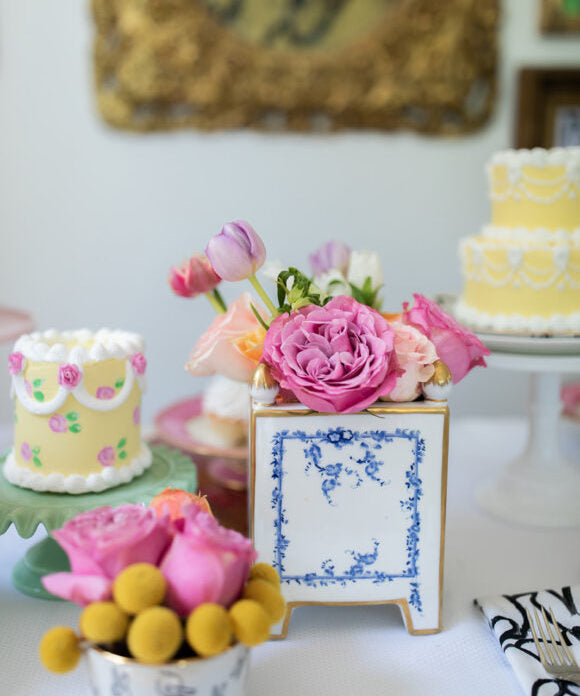 flowers and cakes on a table for mothers day