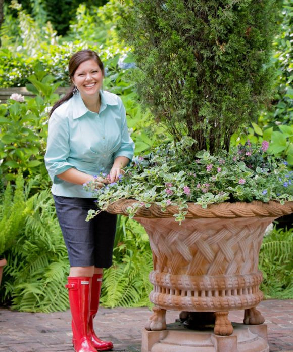 carmen johnston with large planter and wearing red boots