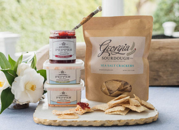 proper pepper pimento cheese stacked with raspberry pepper jelly and shown with crackers