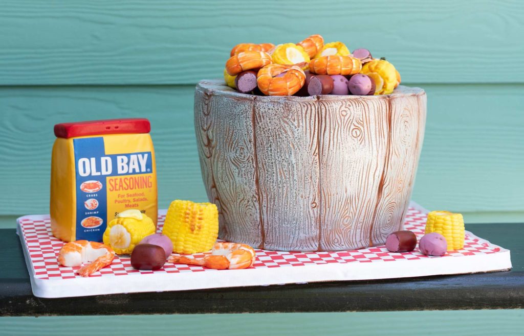 low country boil cake sculpted to look like a pot of seafood corn and potatoes with old bay seasoning and corn on the cob