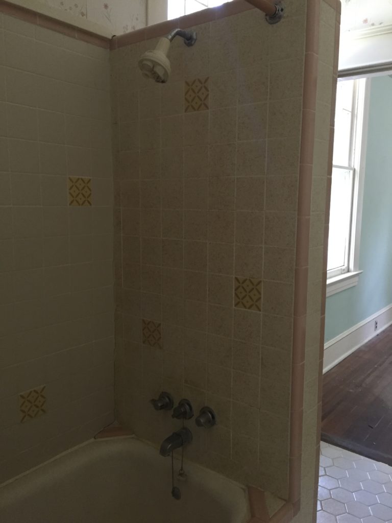 retro bathroom with dusty pink tile in shower bath