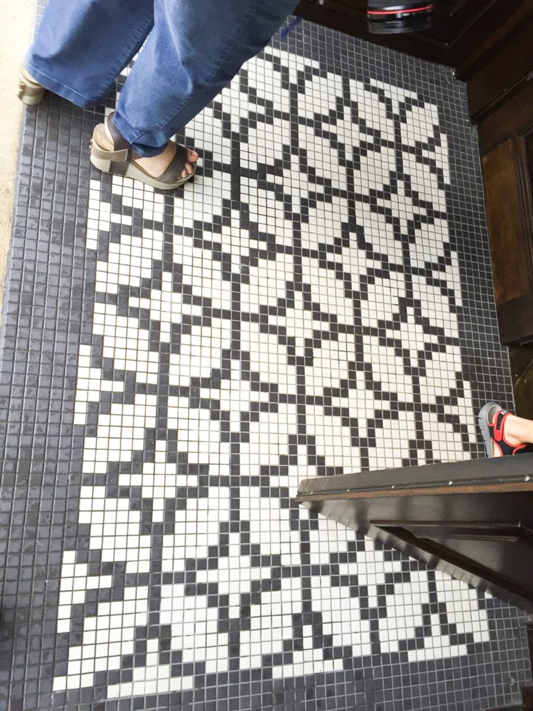 black and white retro tile floor with repeating t pattern