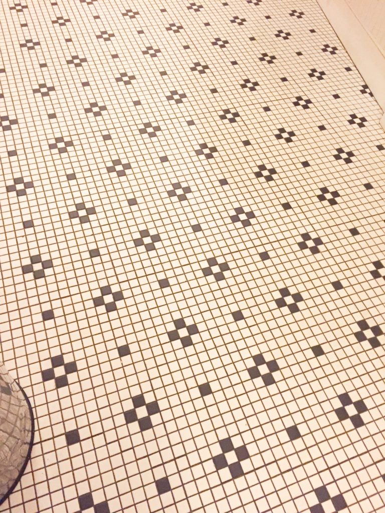 black and white tile flooring with retro feel and diamond pattern