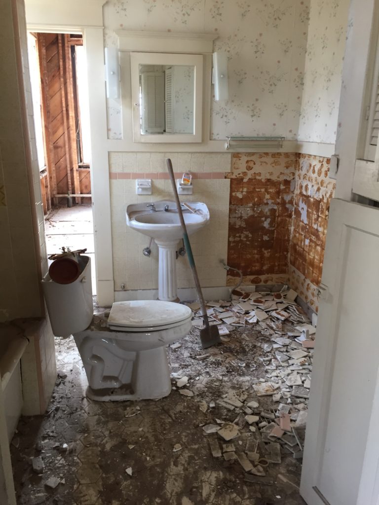 vintage bathroom remodel demolition broken tiles on floor br