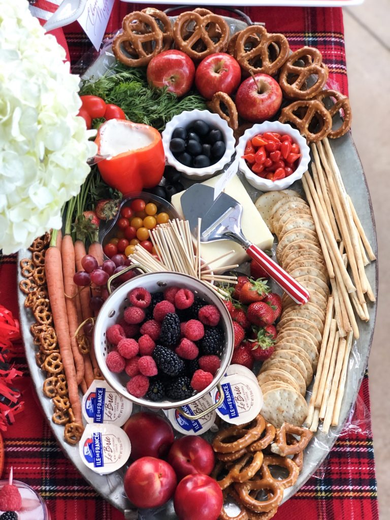 large cheese board with fruit and crackers