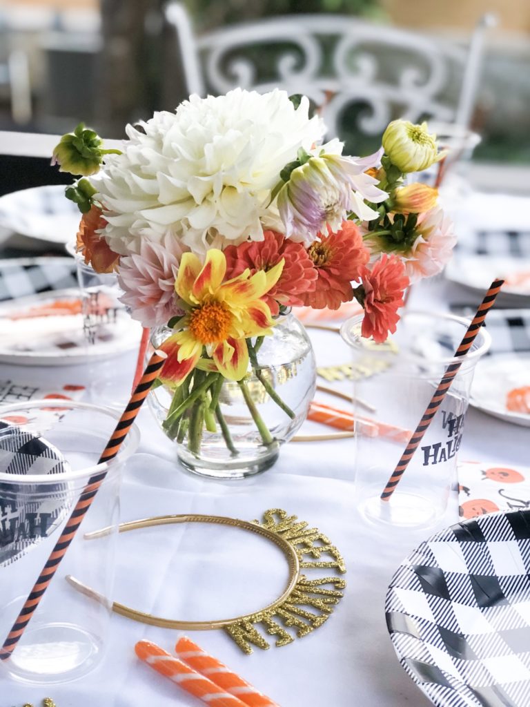 Halloween party table setting with headbands and flowers