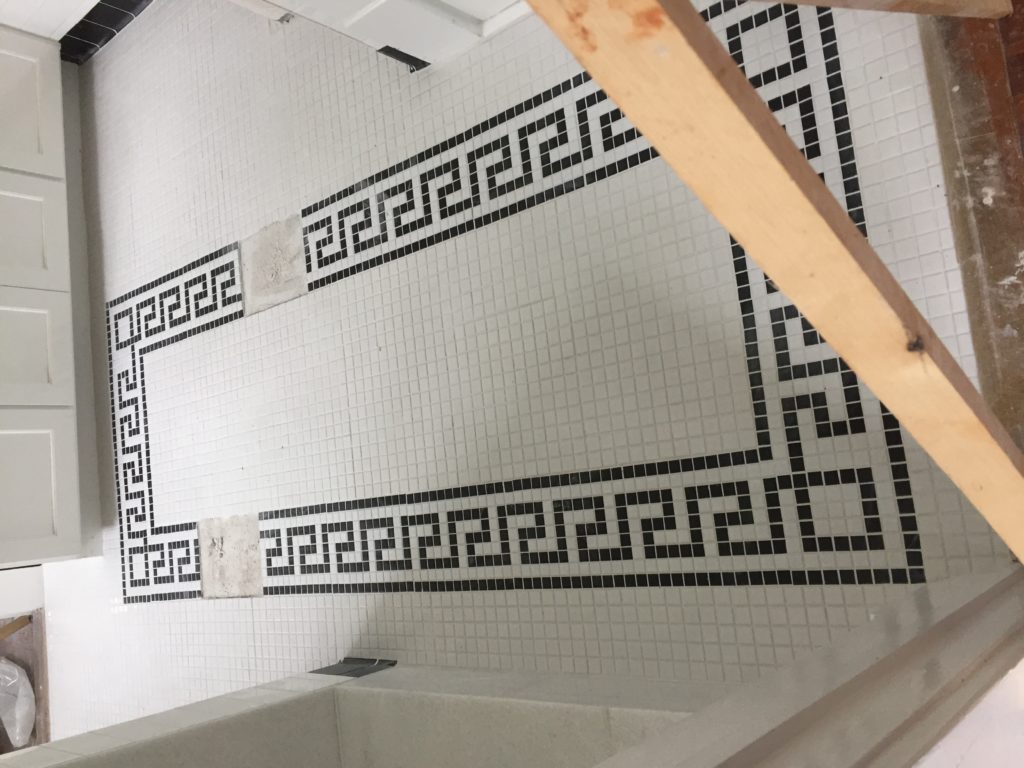 greek key tile floor in bathroom