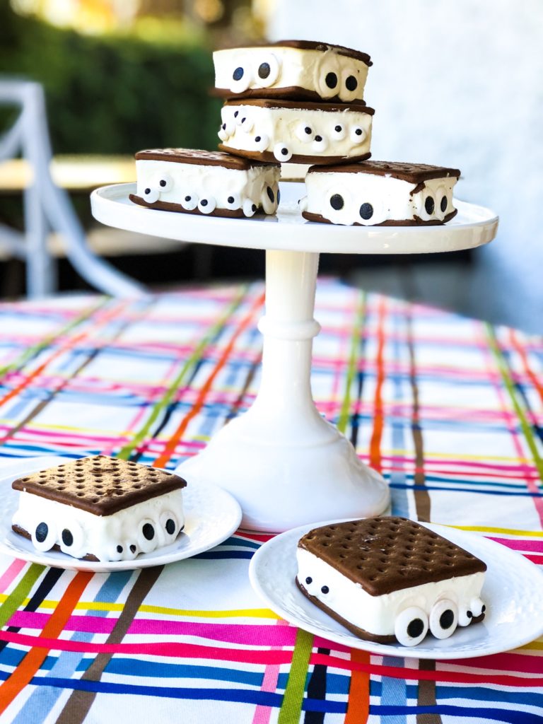 ice cream sandwich ghosts with candy eyes peeping out from the ice cream