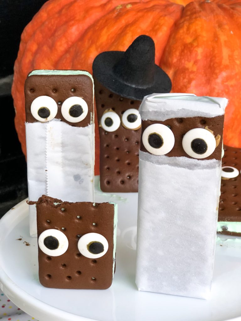 Halloween ice cream sandwiches decorated to look like mummy witch and frankenstein