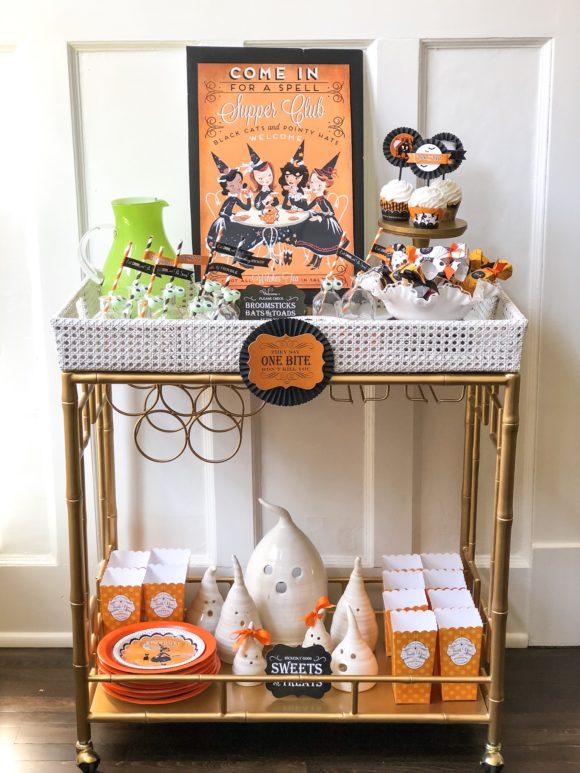 bar cart decorated for halloween with cupcakes drinks popcorn candles