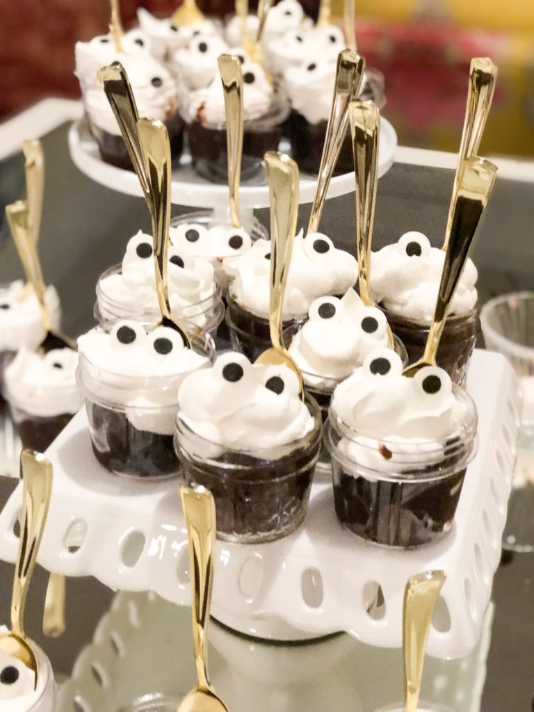 Individual servings of brownie trifles with candy eyes and gold spoons