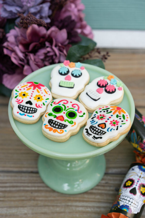 cake stand with day of dead skull cookies in two different styles