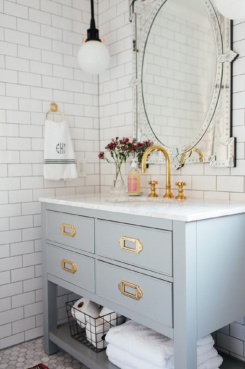 bathroom with white subway tile and brass hardware