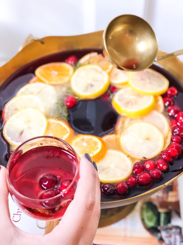 cranberry cocktail served in a brass bowl with ice ring