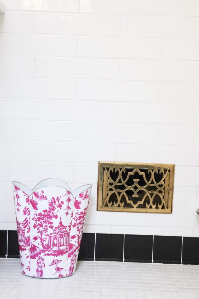 pink toile trash can in black and white bathroom