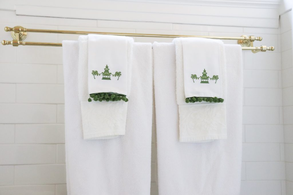 white towels on double brass rack with pagoda tea towels 