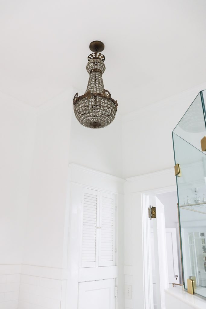 antique chandelier hanging in bathroom
