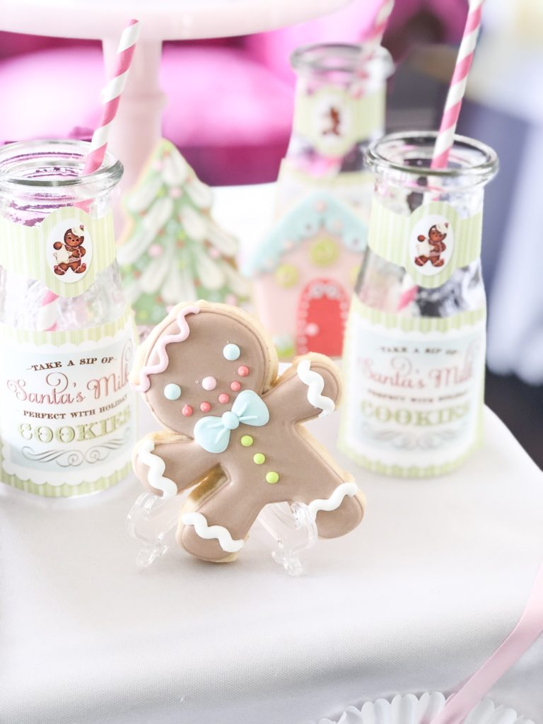 milk and cookies with decorated cookies and glass bottles