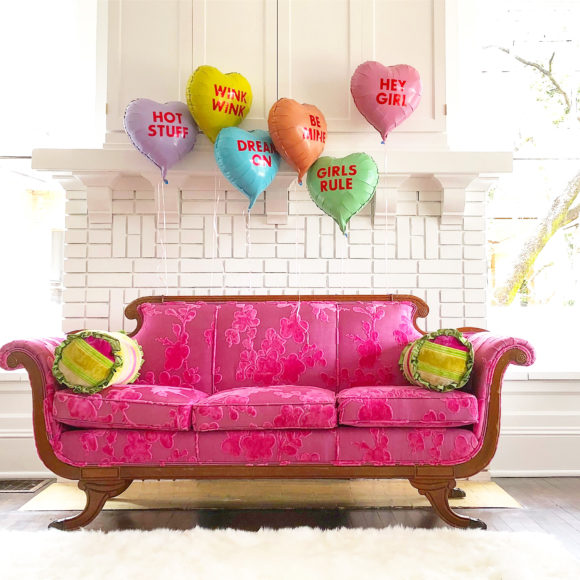 supper club conversation heart balloons above pink sofa