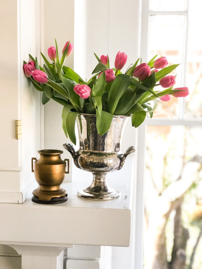 loving cups on mantle with tulips