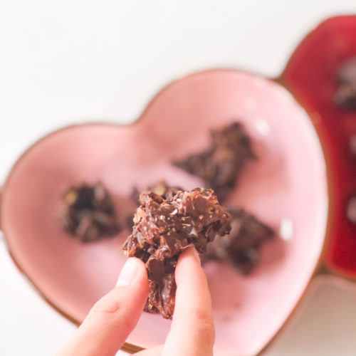 chocolate pecan candy being picked up from plate