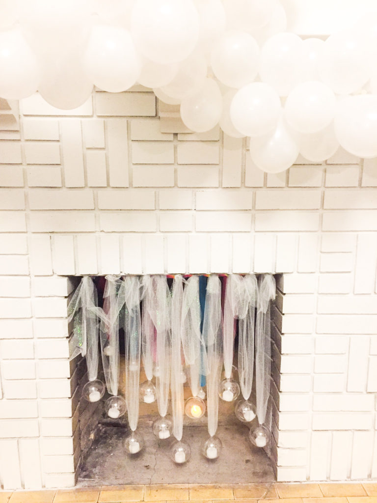 supper club fireplace with clear ornaments with lights and balloon garland