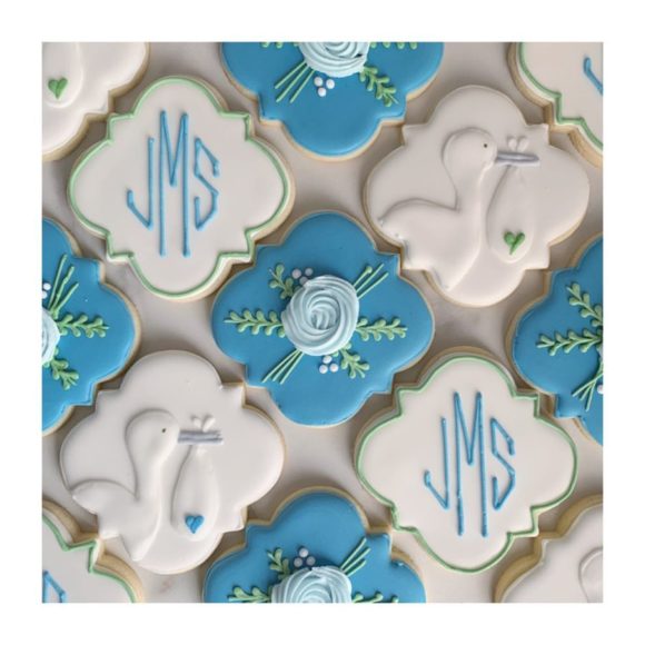 decorated cookies in aqua blue and white with monograms and storks