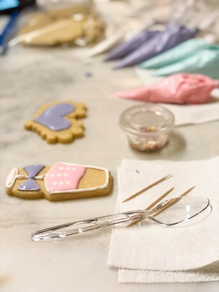 champagne glass cookie and heart cookie on white paper with clear fork